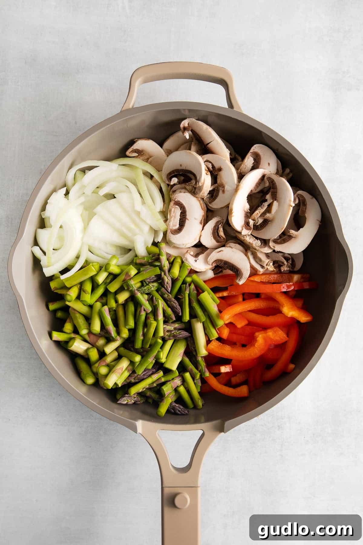 Sautéing Fresh Vegetables for Savory Crepe Filling A vibrant mix of red bell peppers, mushrooms, onions, and asparagus sautéing in a hot skillet, radiating enticing aromas.