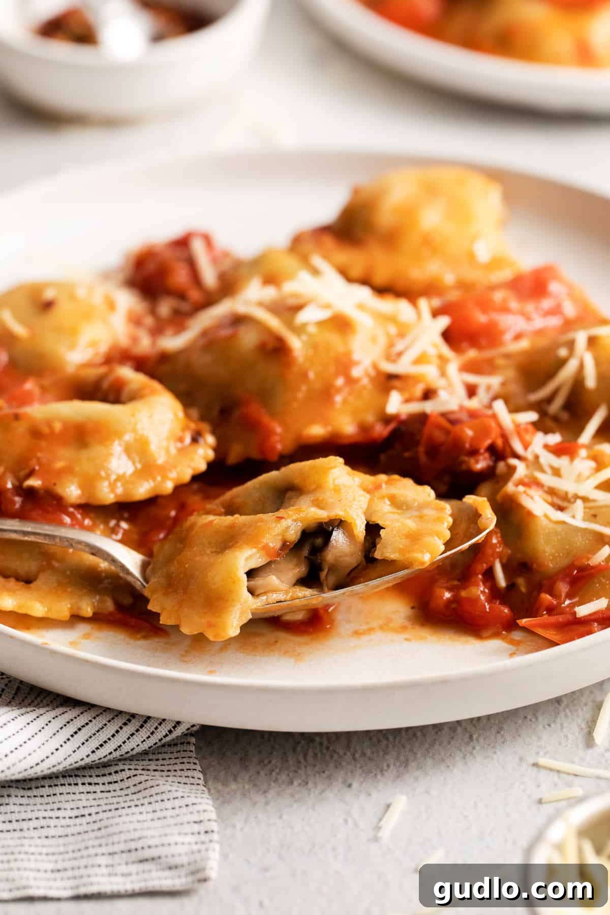 Plated homemade mushroom ravioli, garnished and ready to eat.