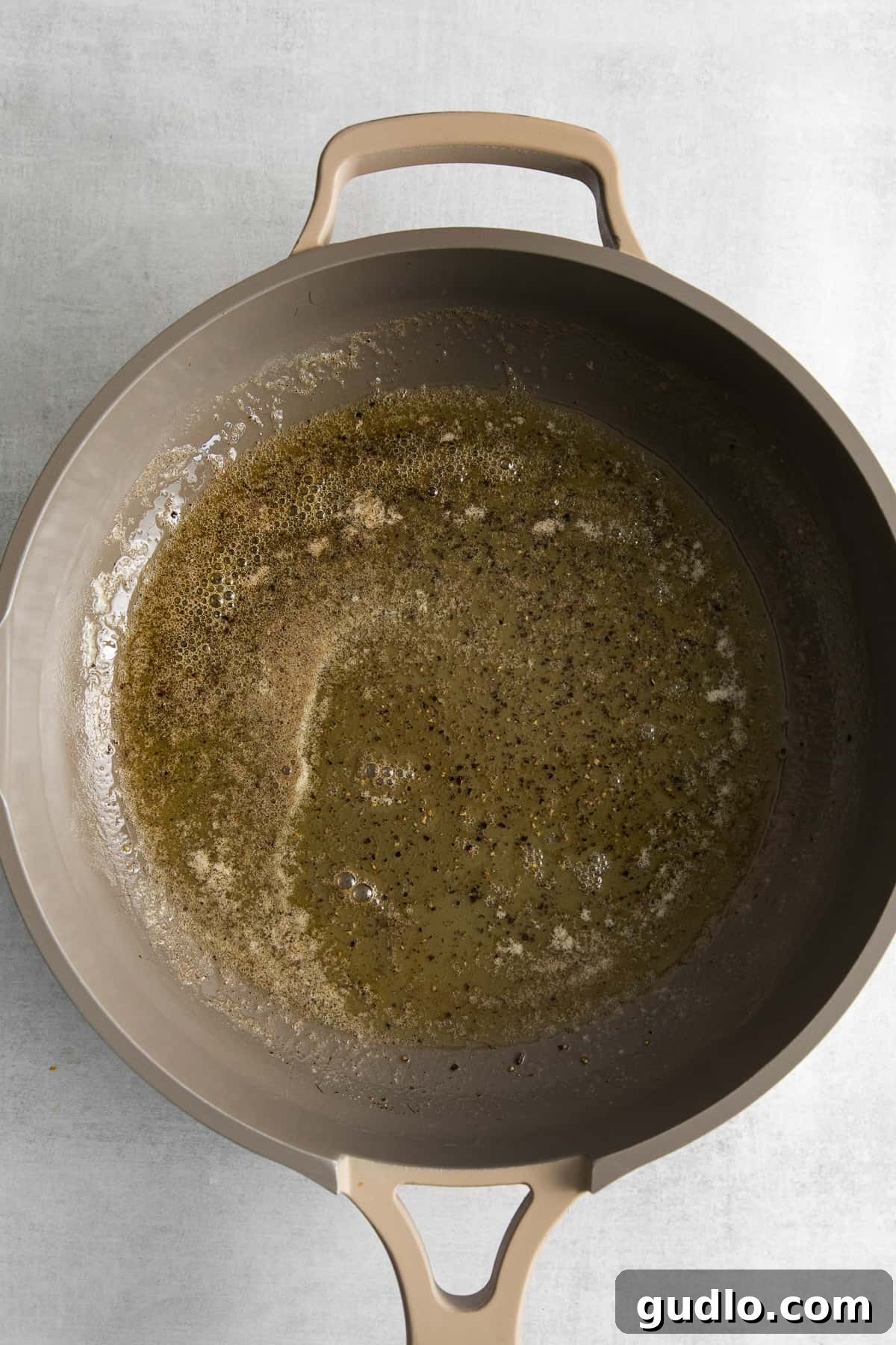Butter and pepper sauteing in a skillet.