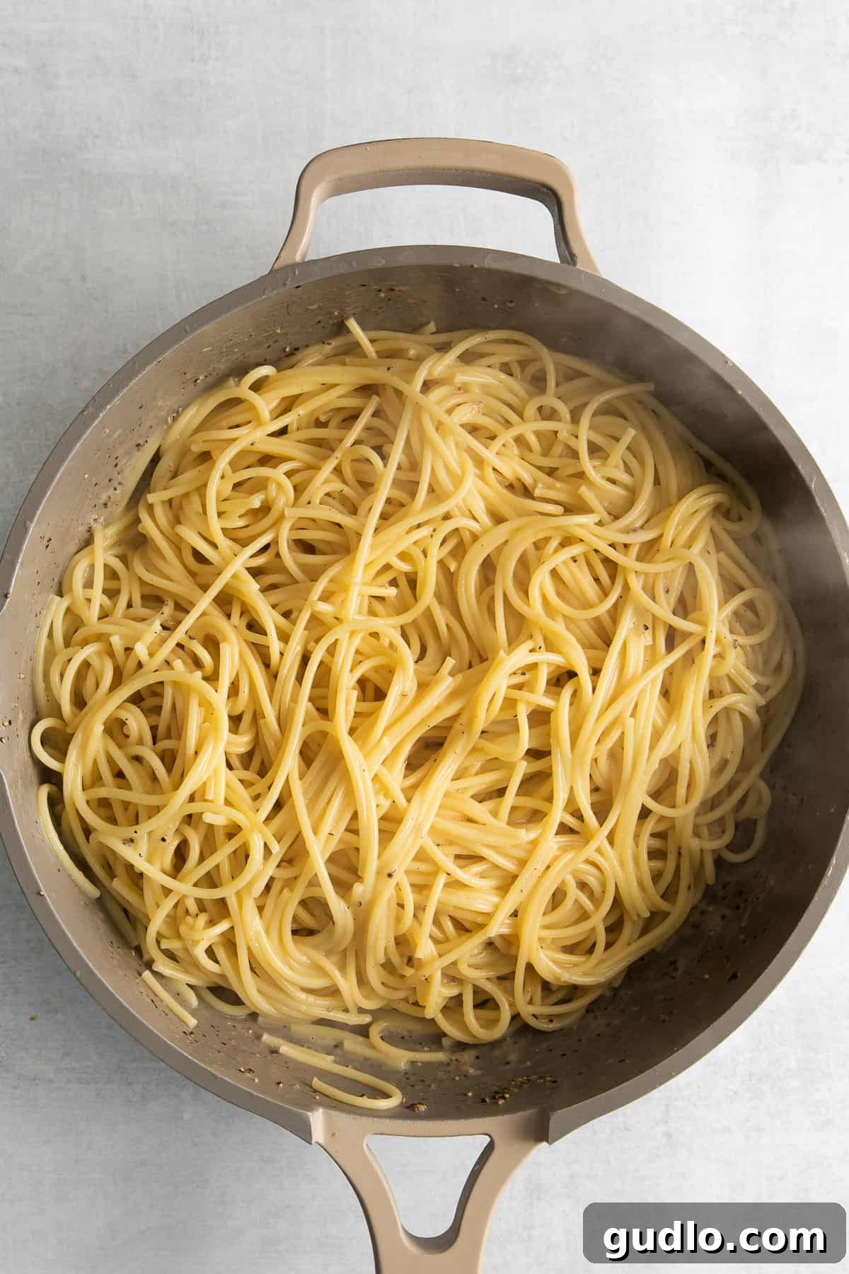 Cacio e pepe noodles in a skillet.