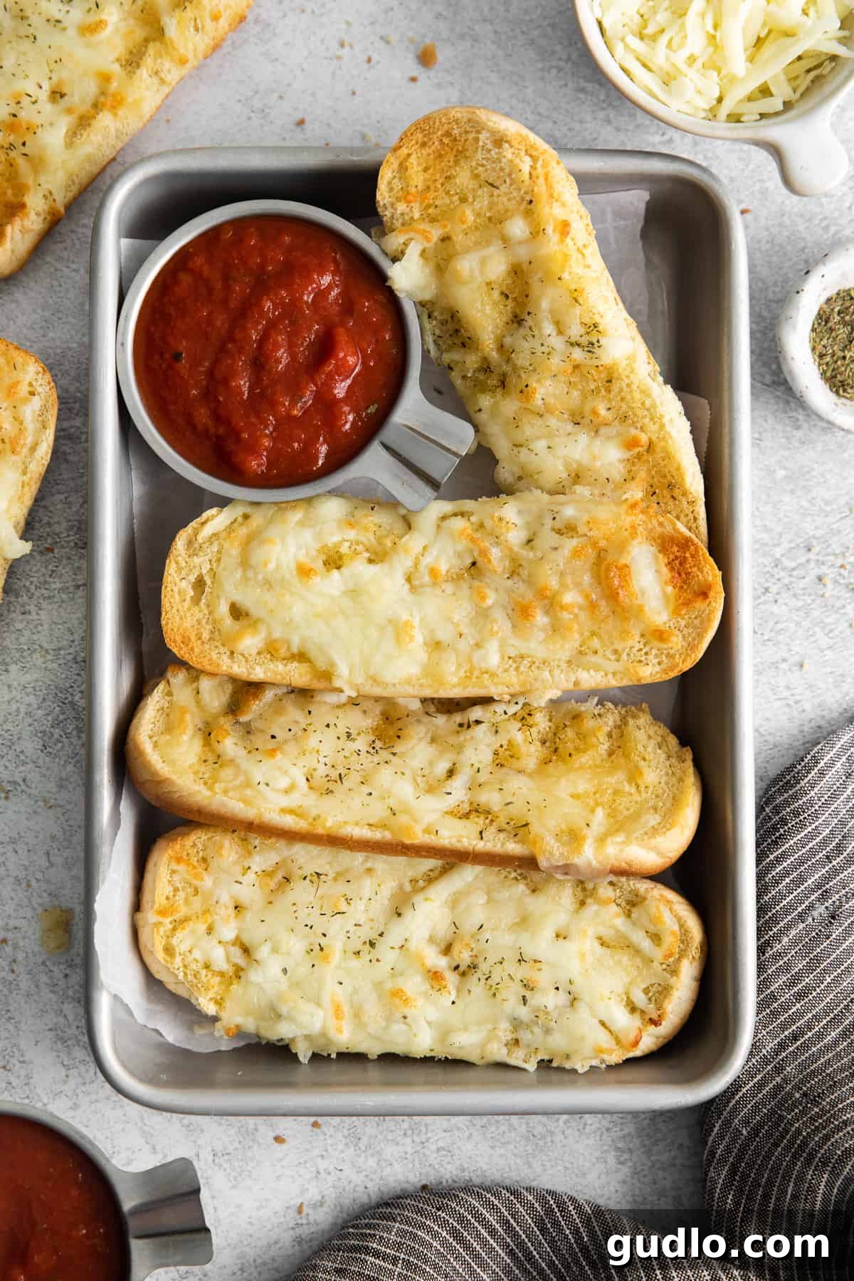 Classic Italian Dunkers with Marinara Dip Golden brown Italian dunkers on a baking sheet, ready to be served with a bowl of vibrant marinara sauce.