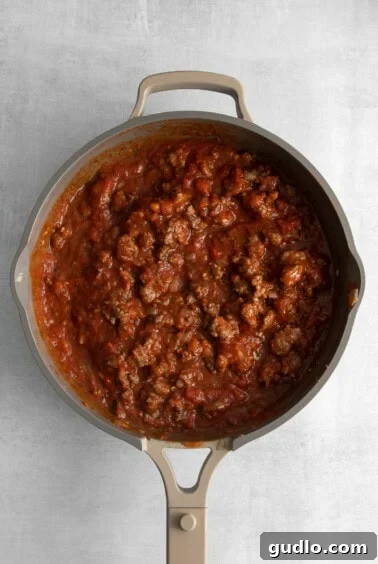 Homestyle Cottage Lasagna 10 Red sauce for the cottage cheese lasagna simmering in a pan.