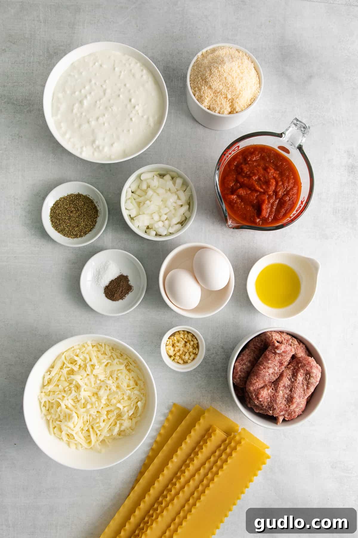 Homestyle Cottage Lasagna 3 Individual bowls holding cottage cheese, parmesan cheese, and shredded mozzarella, showcasing the key dairy ingredients for lasagna.