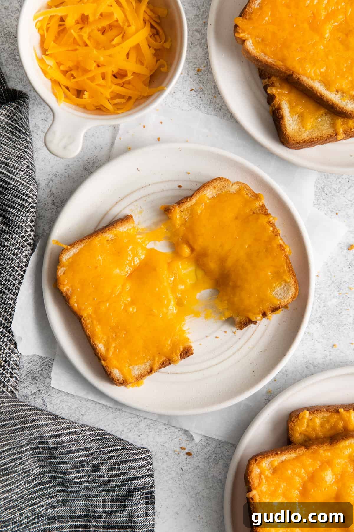 Golden Cheesy Toast 2 Golden brown, crispy cheese toast on a white plate, ready to be served.