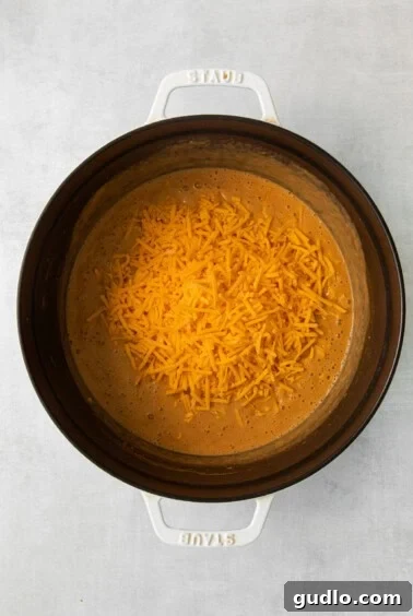 a crock pot full of cheesy nachos.
