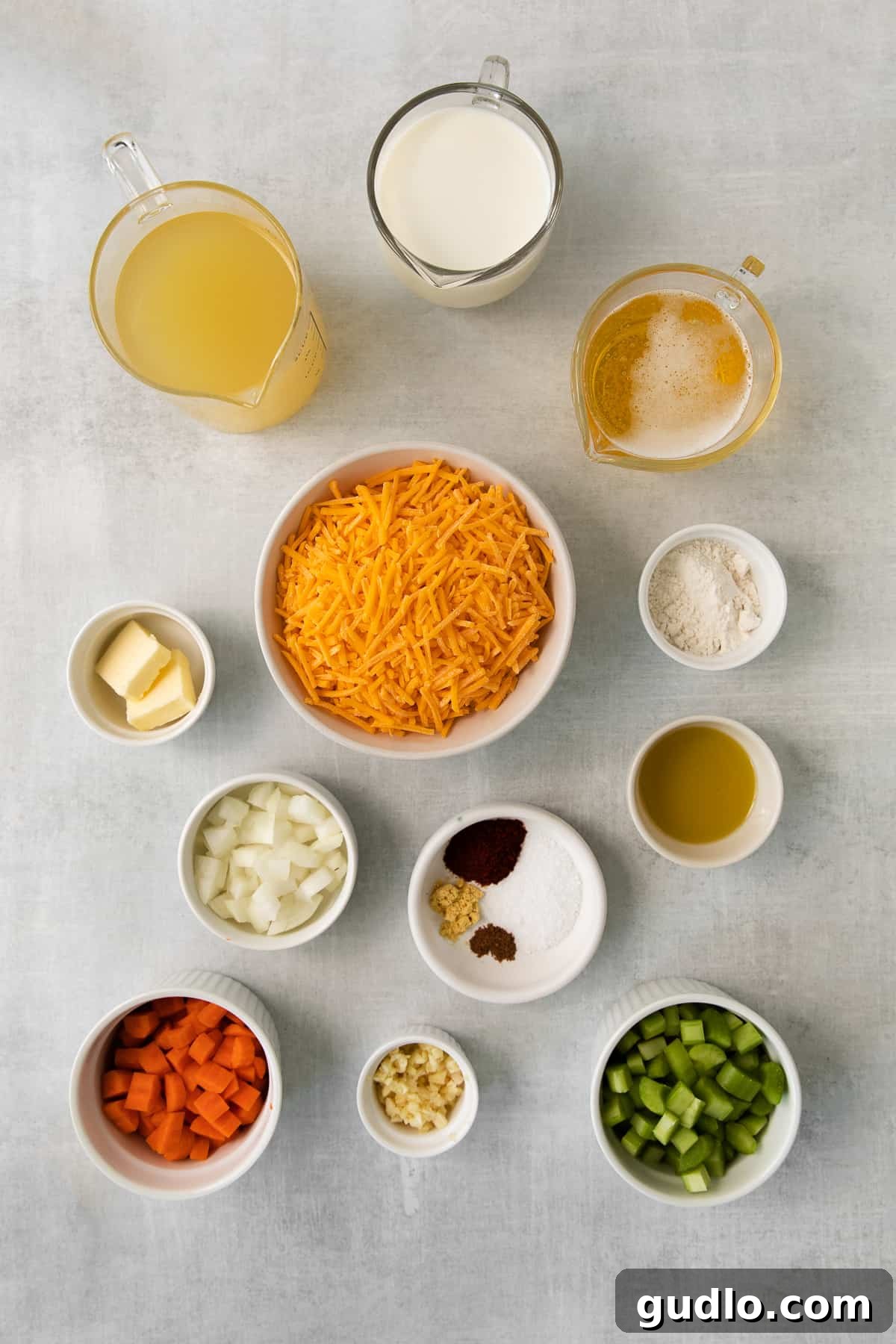A vibrant selection of fresh ingredients laid out for making Wisconsin cheese soup.