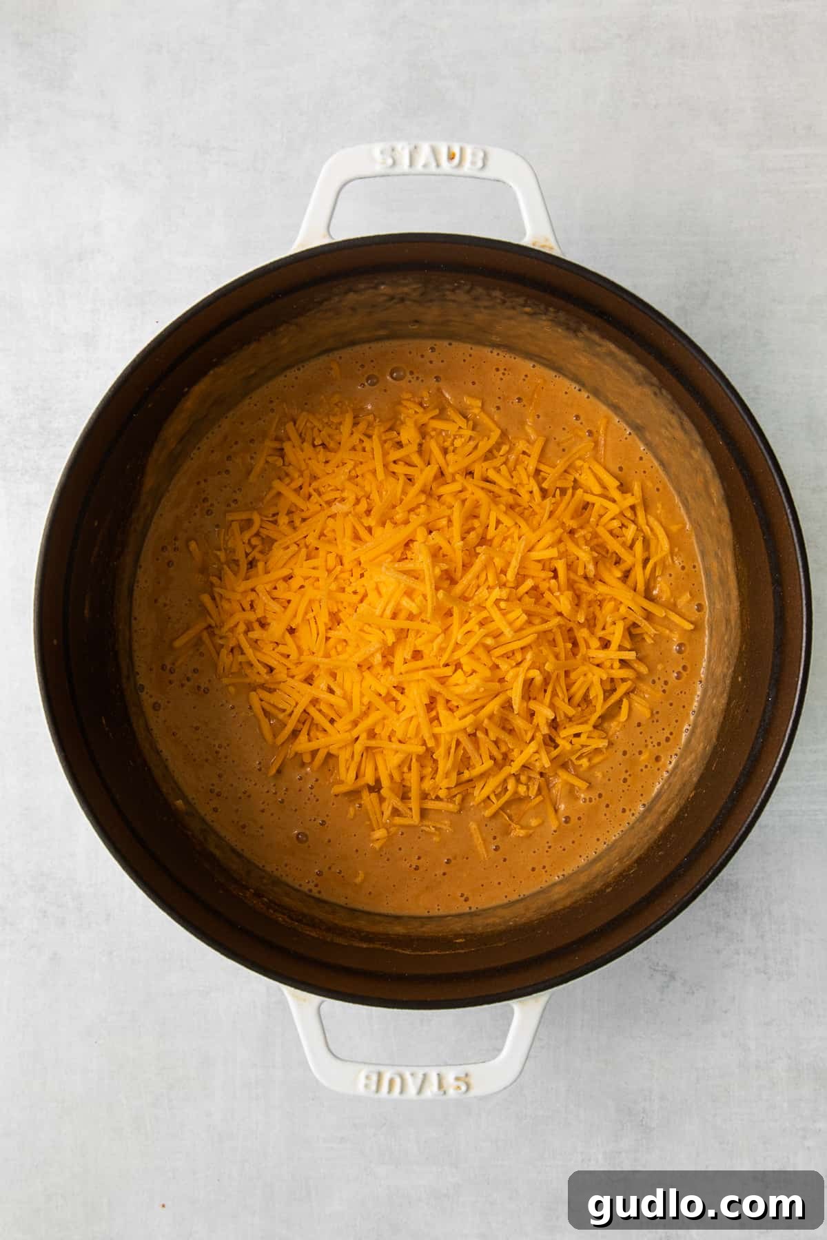 Close-up of Wisconsin cheese soup, showcasing its rich, creamy texture with melted cheddar cheese.