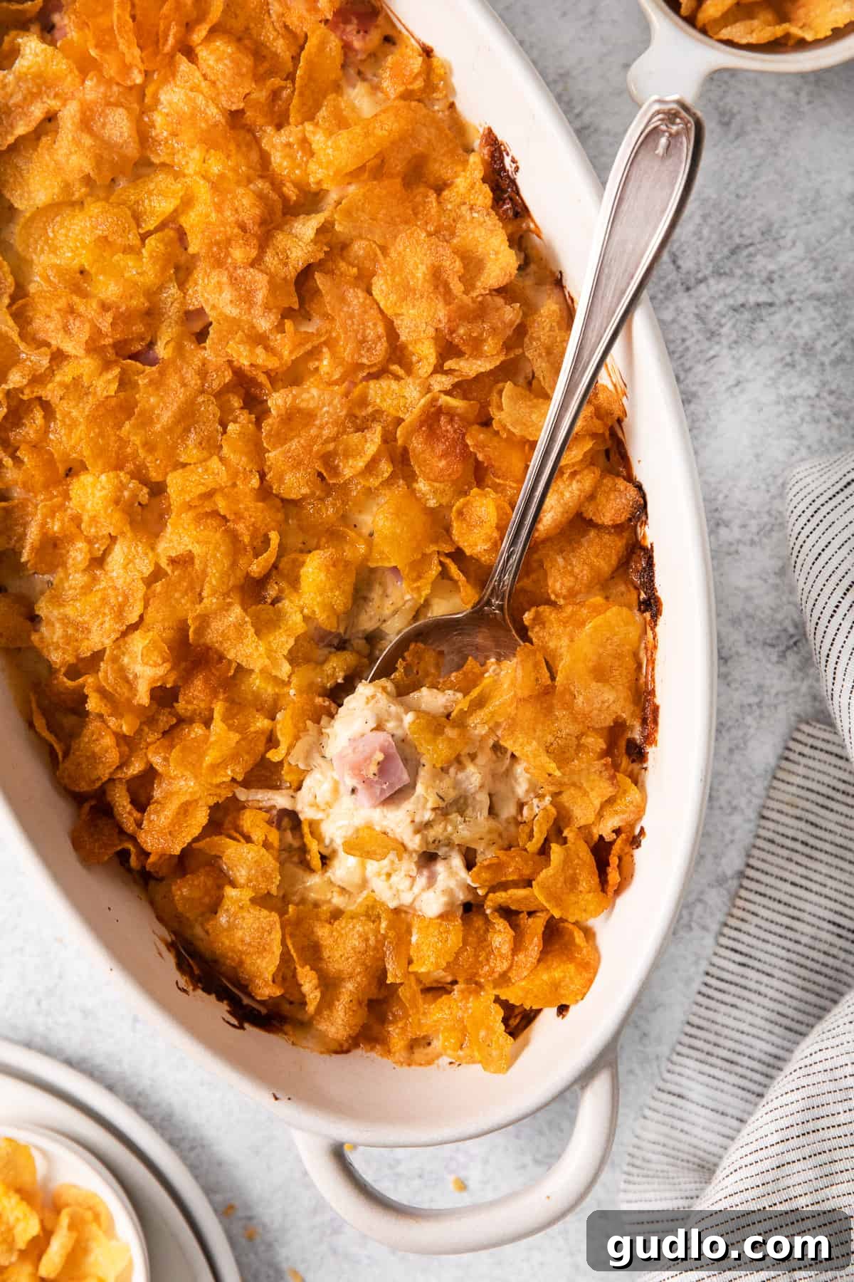 A visually appealing chicken cordon bleu casserole, freshly baked and golden brown, resting in a ceramic baking dish.