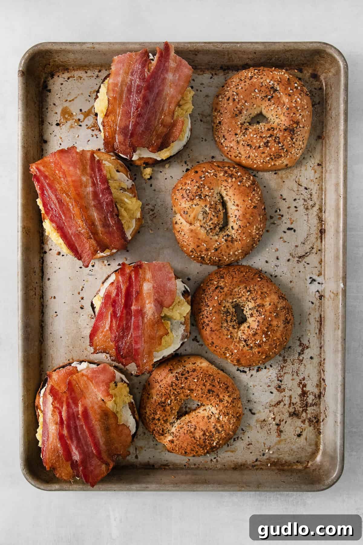 Hearty Morning Bagel Stack 5 Plain bagels arranged on a baking sheet, ready for toasting and seasoning.