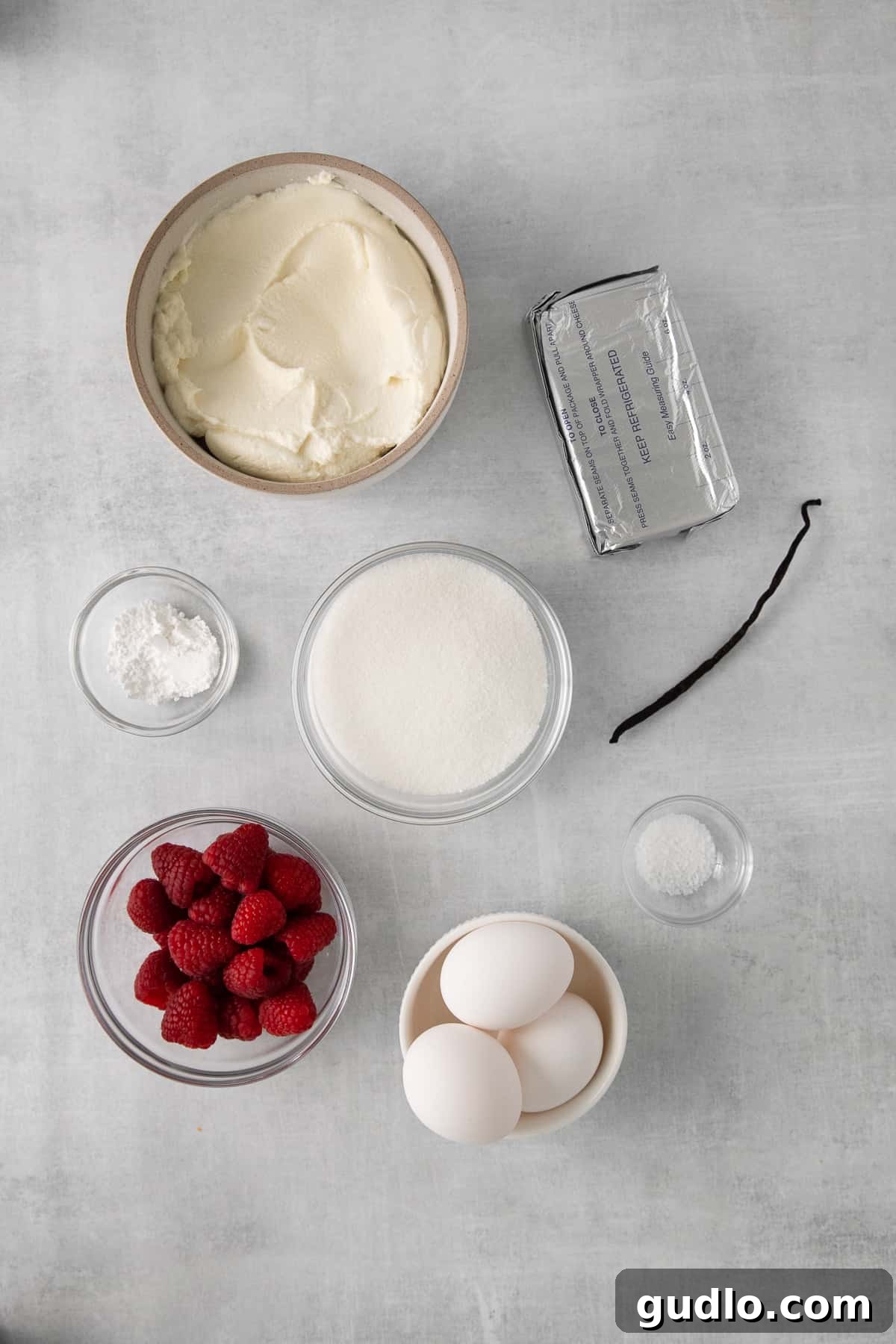 Ingredients for ricotta cheesecake filling laid out on a kitchen counter.