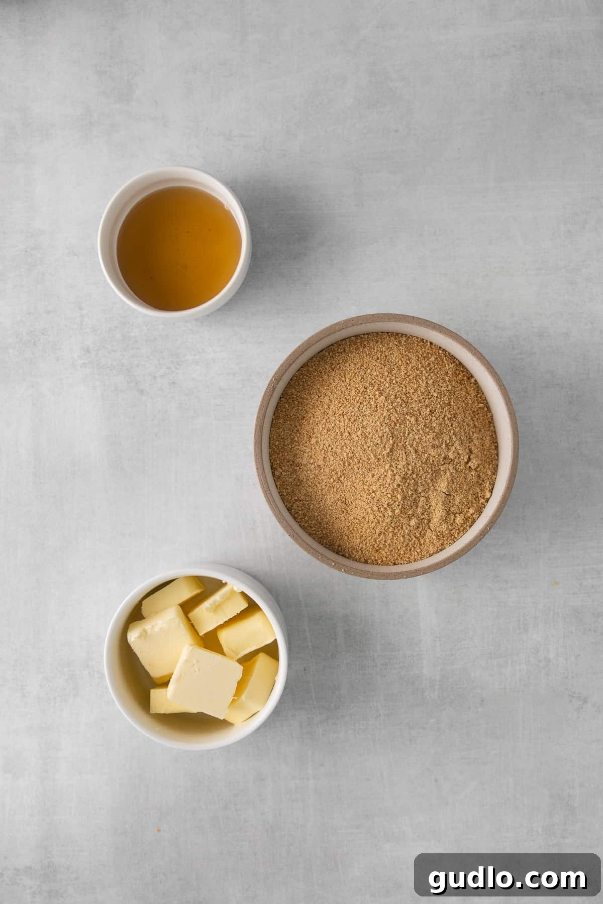 Ingredients for a graham cracker crust, including crumbs, butter, and honey.