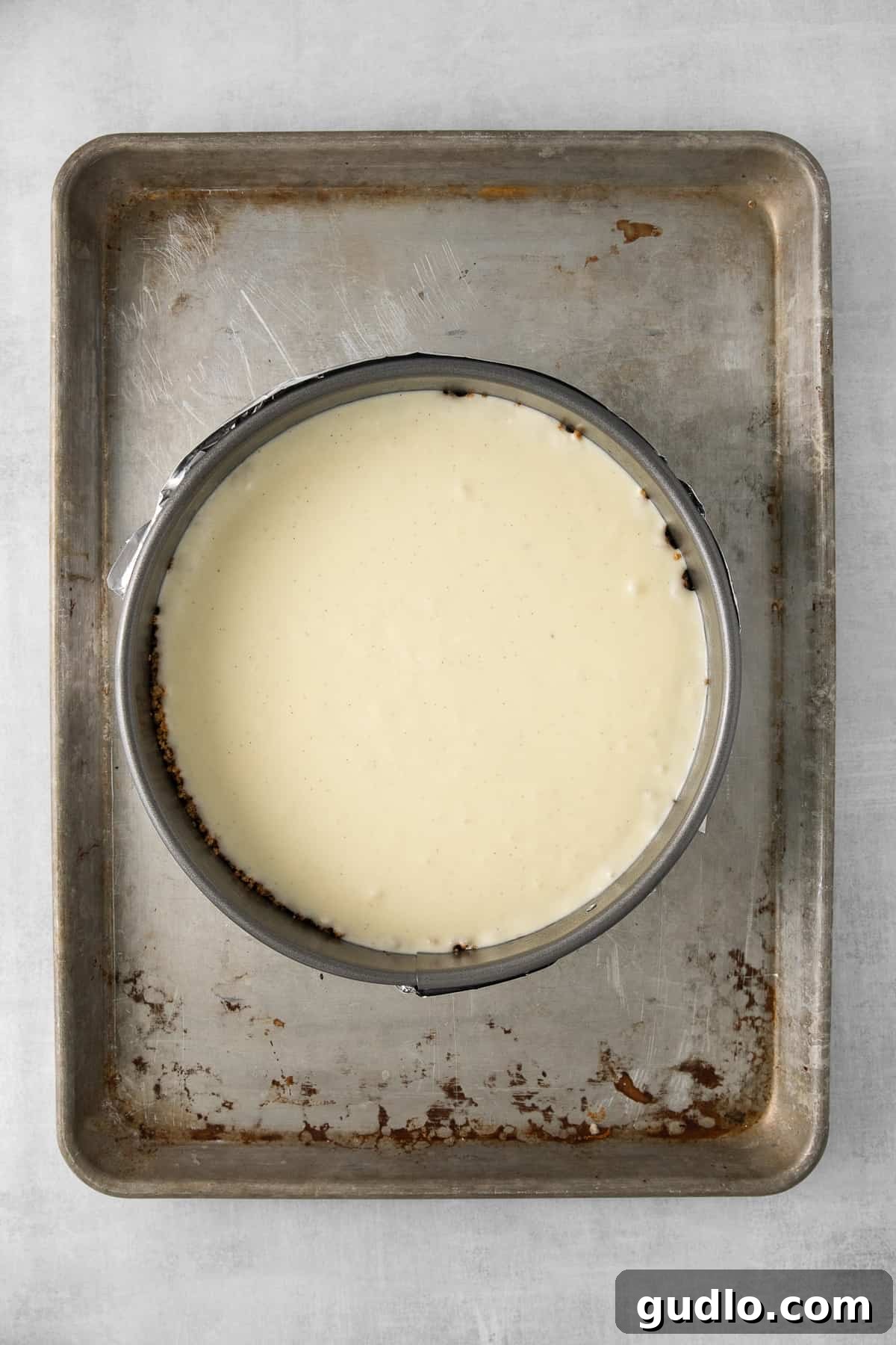 Unbaked ricotta cheesecake in a springform pan, ready for the oven.