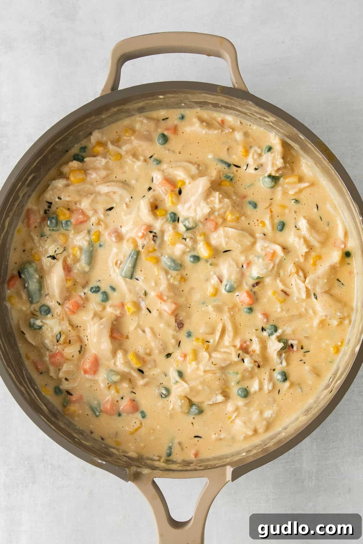 Chicken Pot Pie Casserole Filling in Skillet Creamy chicken pot pie casserole filling ready in a skillet before transferring to a baking dish.