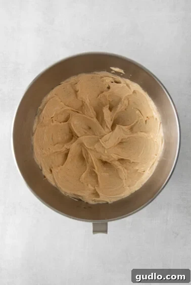 Peanut butter cream cheese frosting being mixed in a bowl.