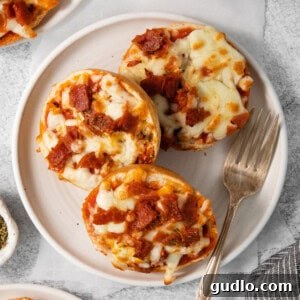 Quick Pizza Bagel Bites 2 A charming plate of delicious mini bagel pizza bites, garnished with herbs, perfect for serving as appetizers or a quick snack.