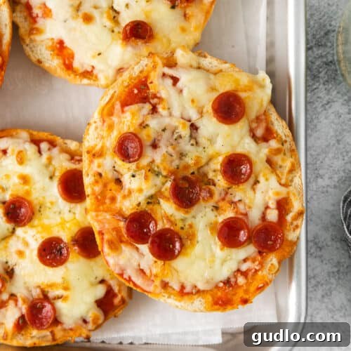 Close-up of perfectly cooked air fryer pizza bagels, showing melted cheese and crispy edges, ready to eat.