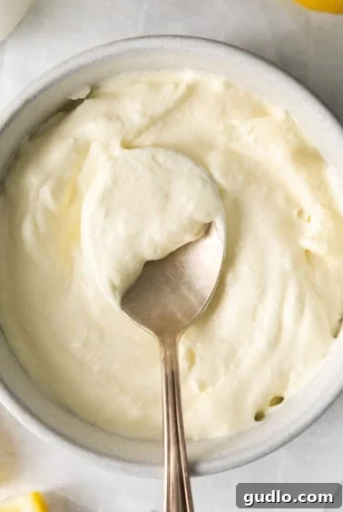 Freshly made homemade mascarpone cheese in a bowl, ready for storage.