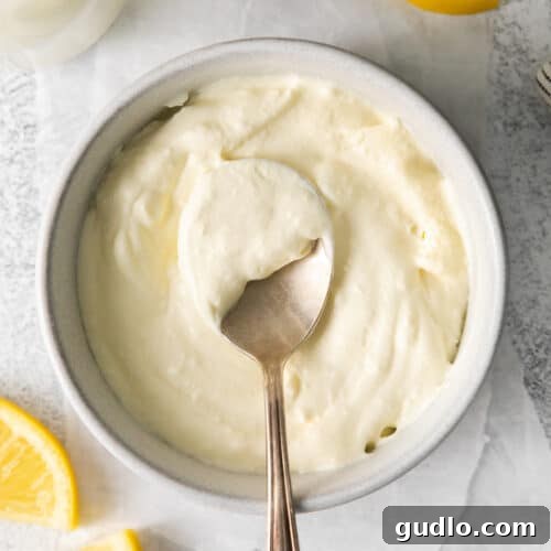 Homemade mascarpone cheese in a bowl, showing its thick and creamy texture.
