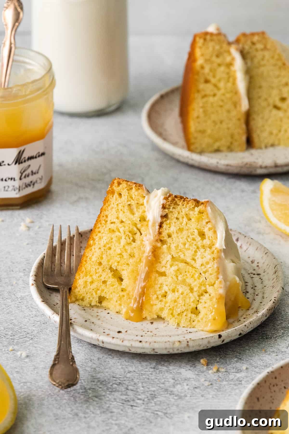 Limoncello Mascarpone Cake with Rich Mascarpone Frosting A slice of limoncello mascarpone cake on a plate, showcasing its beautiful layers and creamy frosting.