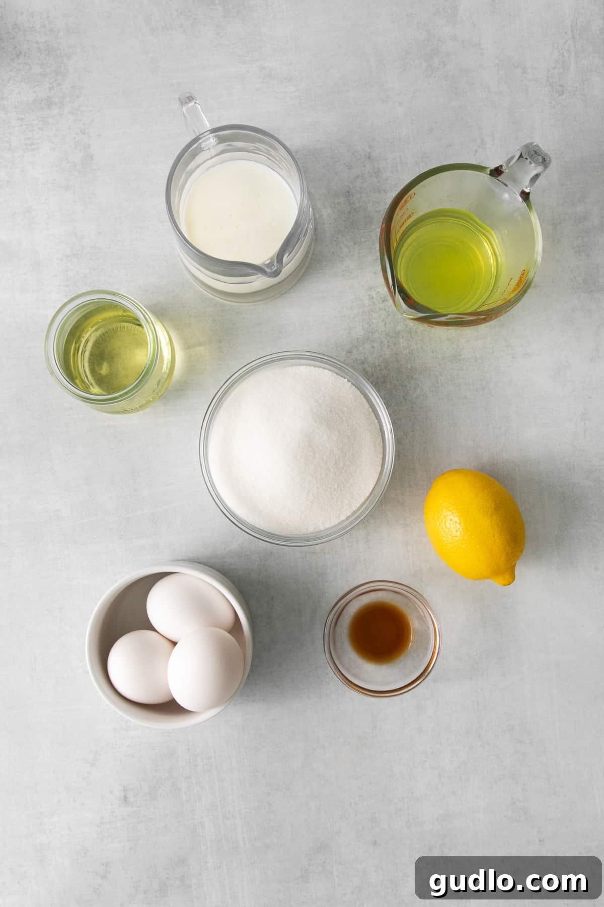 Key Ingredients for Limoncello Mascarpone Cake Various essential ingredients for limoncello mascarpone cake, neatly arranged in bowls and ready for preparation.