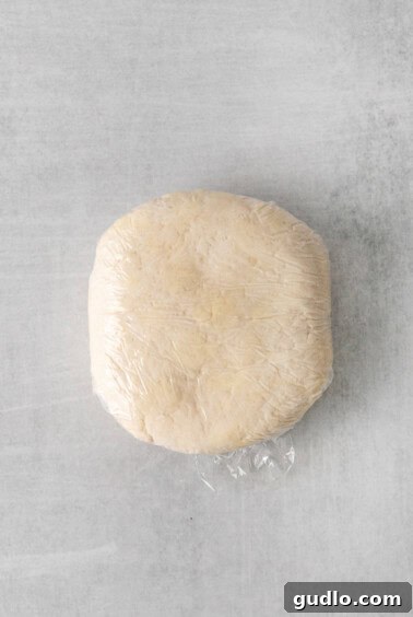 Classic French Quiche Lorraine 3 A bowl with flour and butter being cut into coarse crumbs for pie crust.