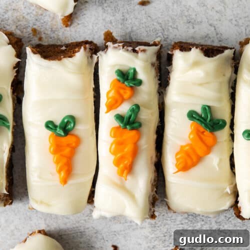 A perfectly squared image of sliced carrot cake bars with cream cheese frosting, ready for the recipe card.