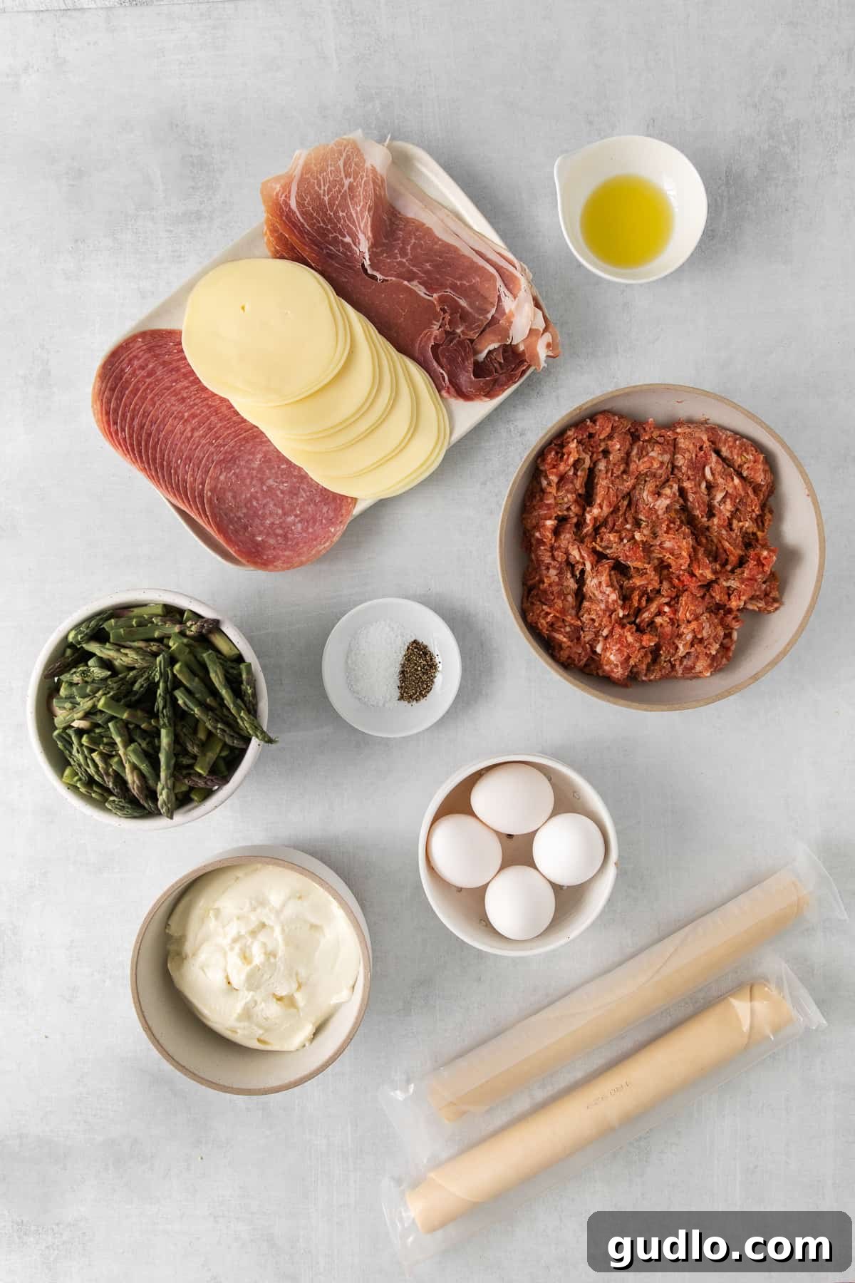 A collection of fresh ingredients for Italian Easter pie arranged in bowls, ready for preparation.
