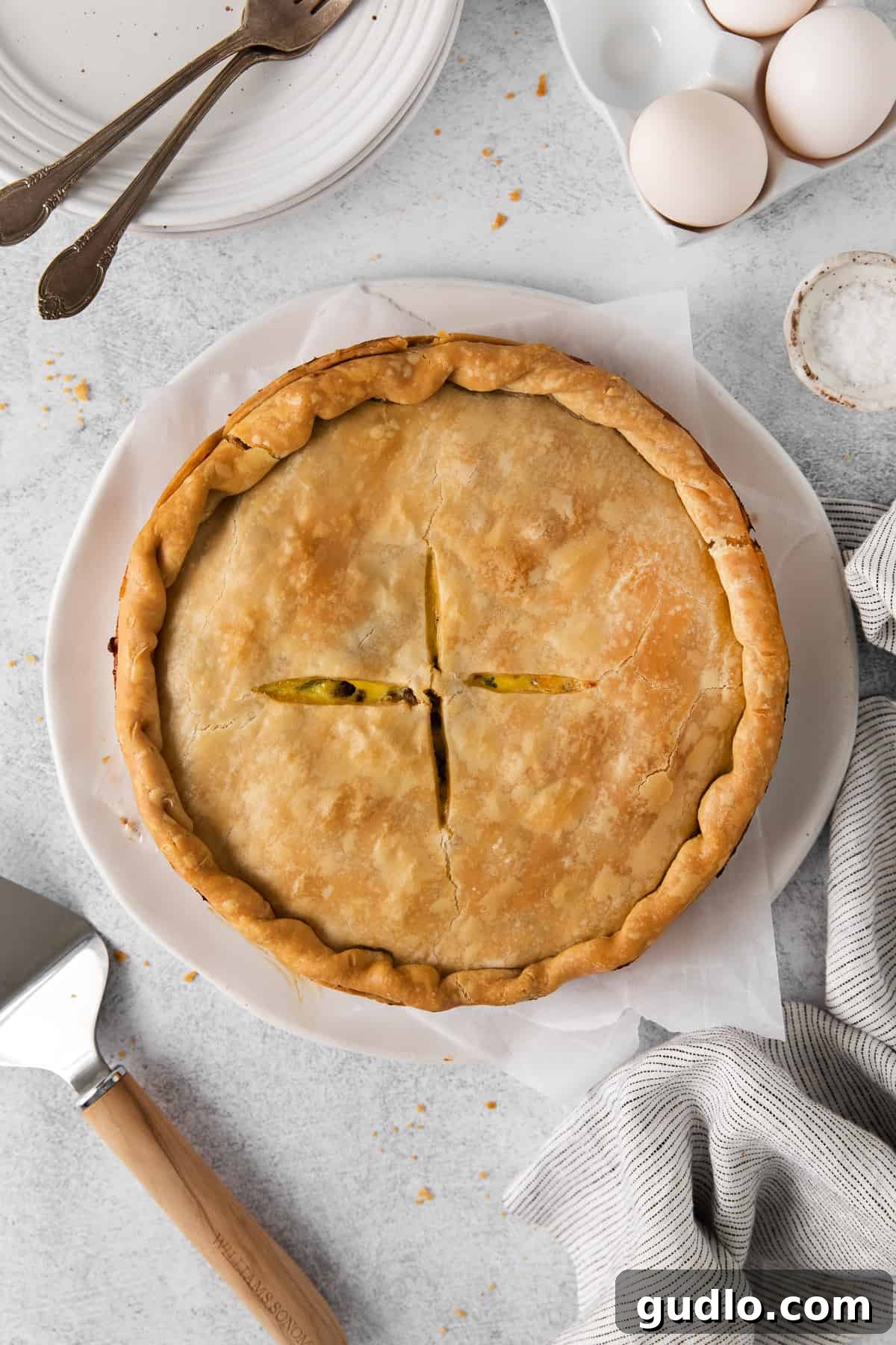 A beautiful, golden-brown Italian Easter pie, just out of the oven, sitting on a plate.