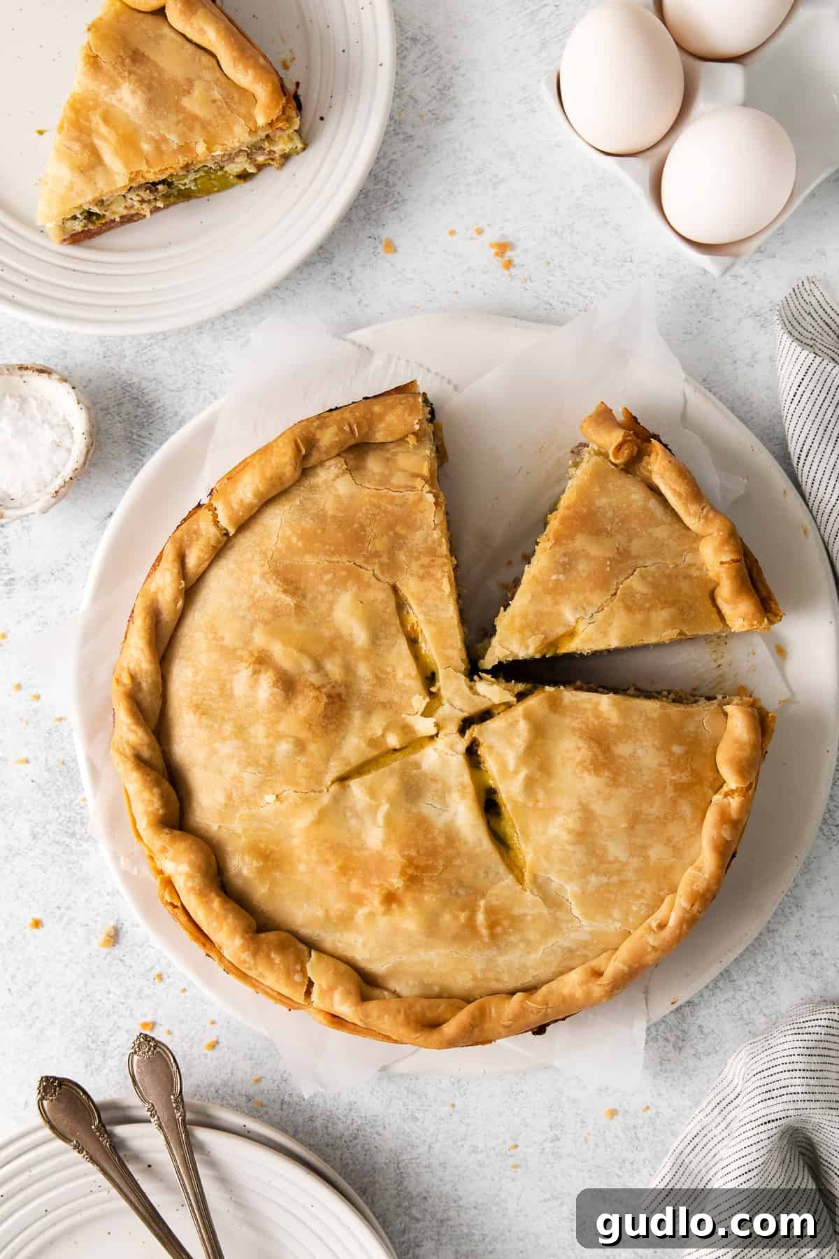 A generous slice of Italian Easter pie on a white plate, ready to be enjoyed.