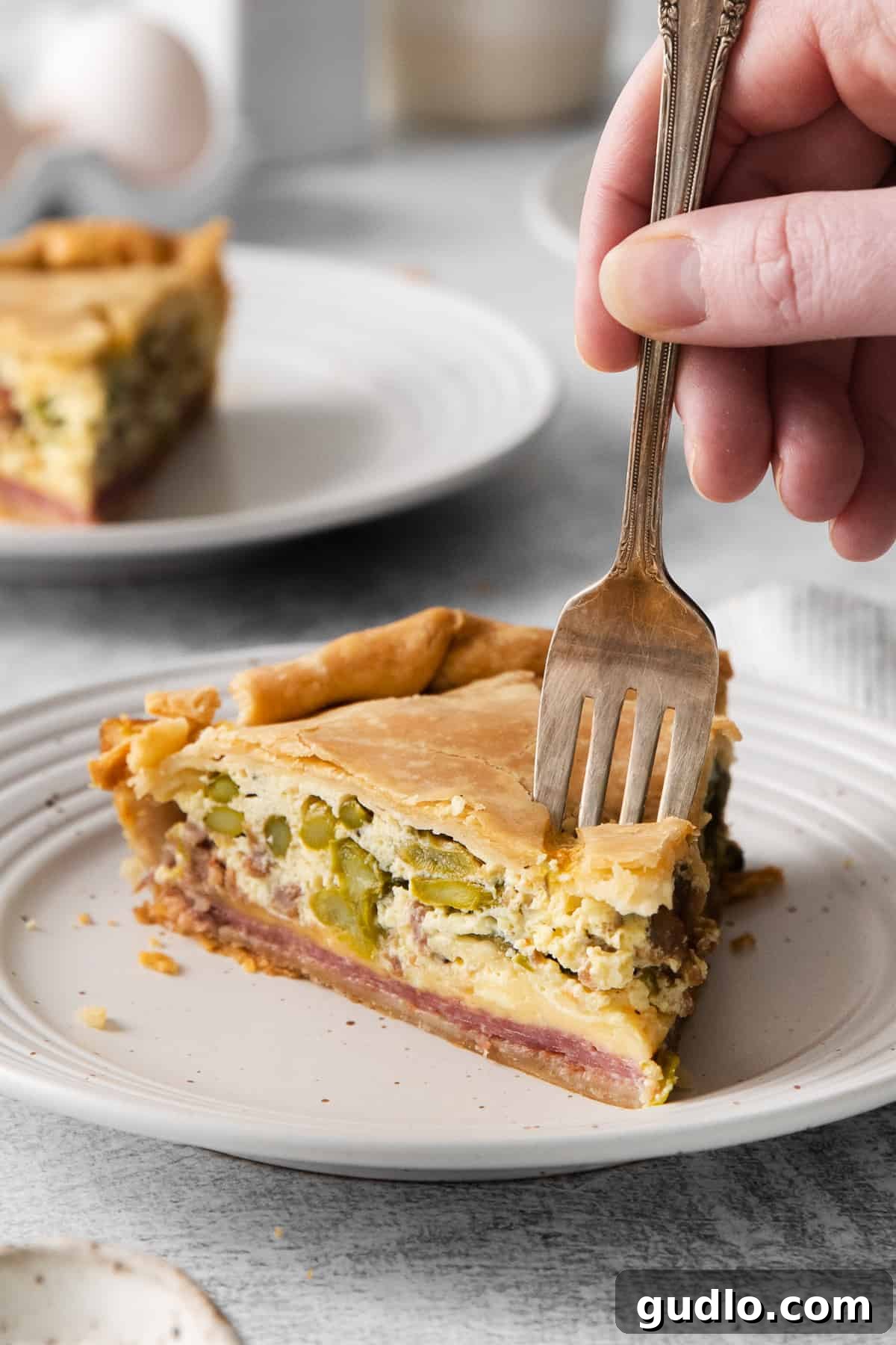 A close-up of a slice of Italian Easter pie on a fork, showing the delicious layers.
