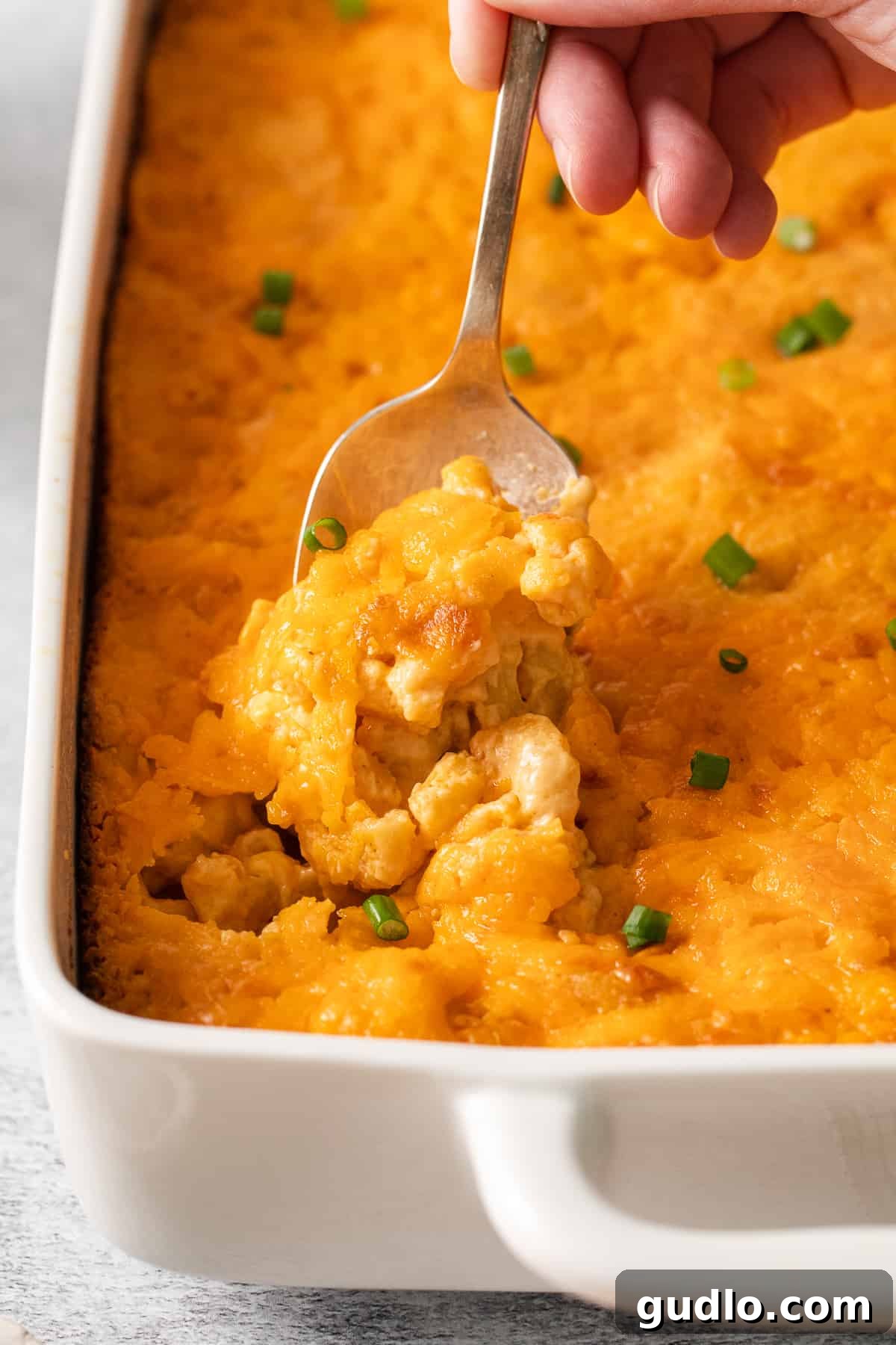 A generous spoonful of creamy Southern baked mac and cheese, ready to be enjoyed.