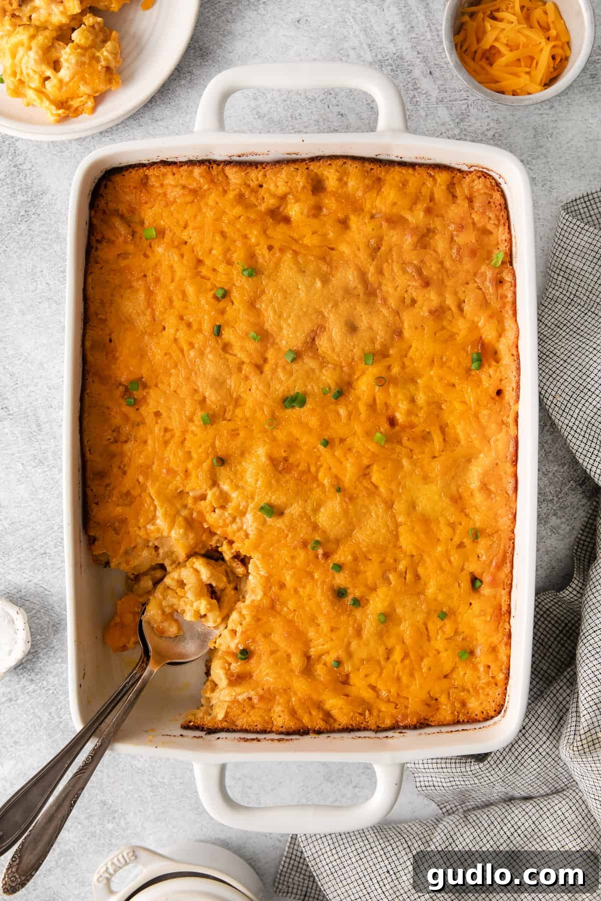 A casserole dish of Southern baked mac and cheese, perfectly golden and ready for reheating.