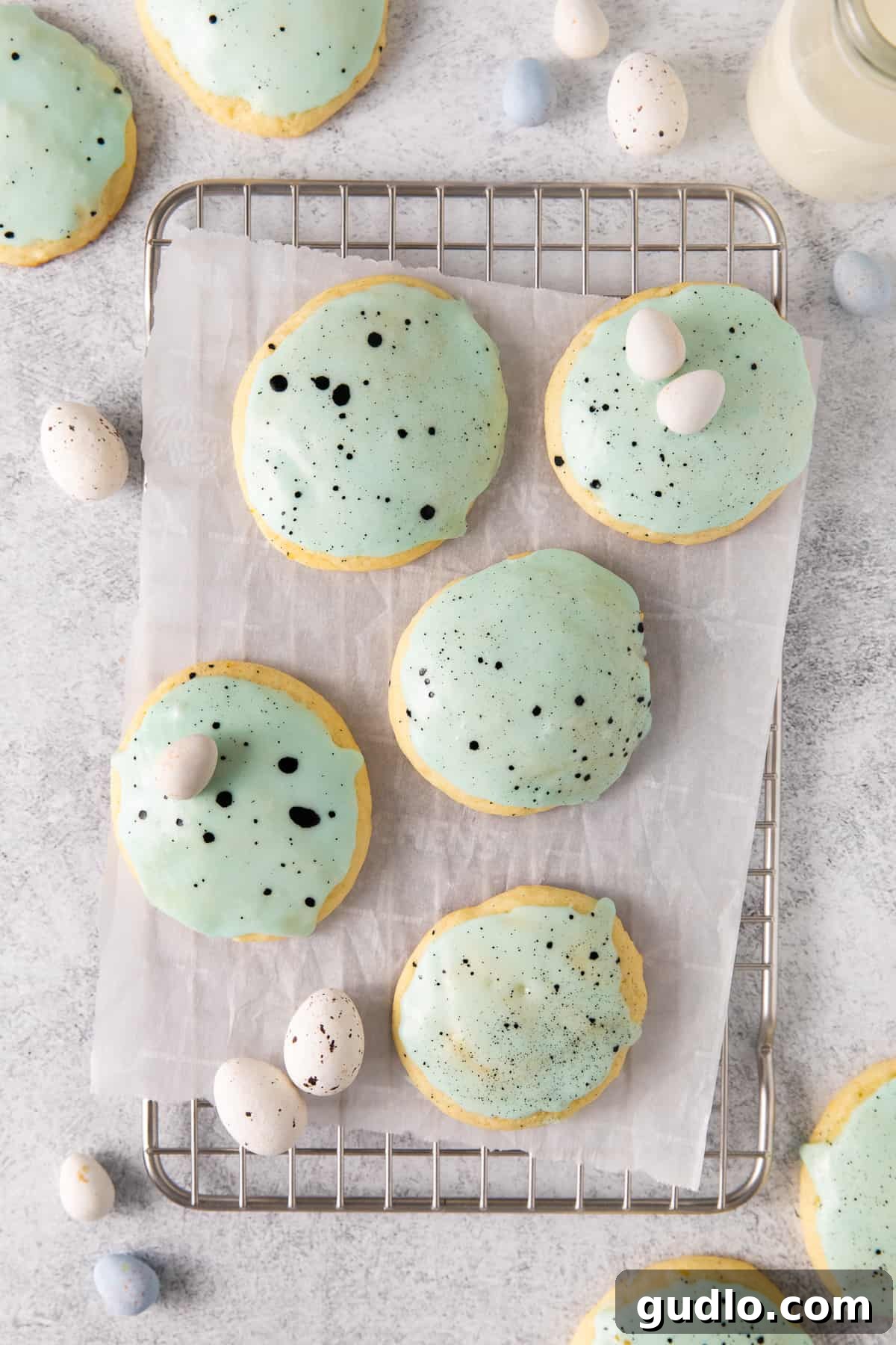 Freshly baked lemon ricotta cookies cooling on a wire rack, ready for glazing.