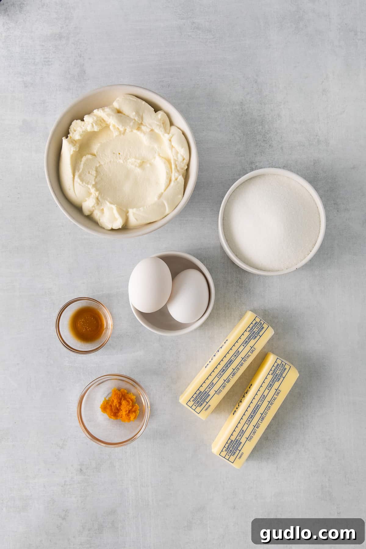 Bowls of various baking ingredients for lemon ricotta cookies, including flour, sugar, and lemon zest.