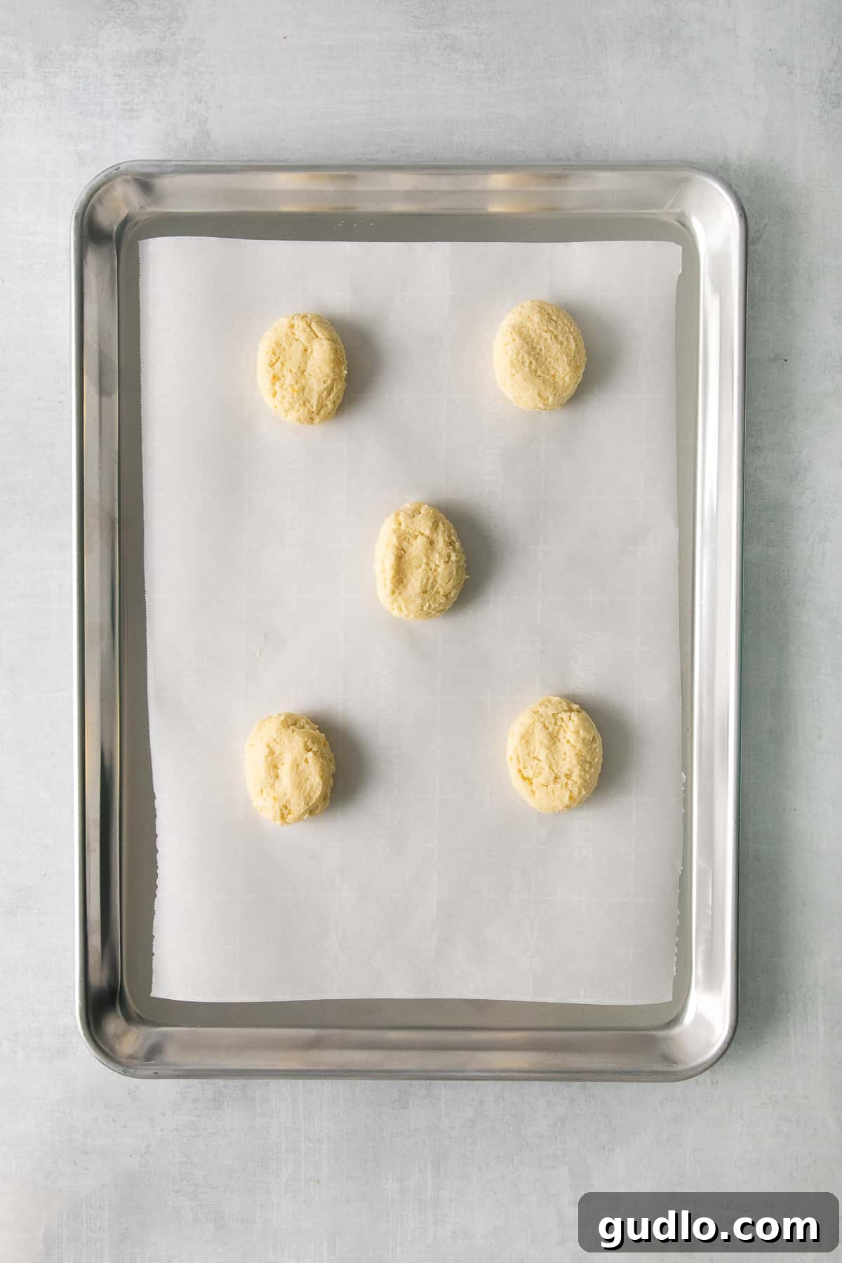 Lemon ricotta cookie dough scooped onto a baking sheet, ready for chilling.