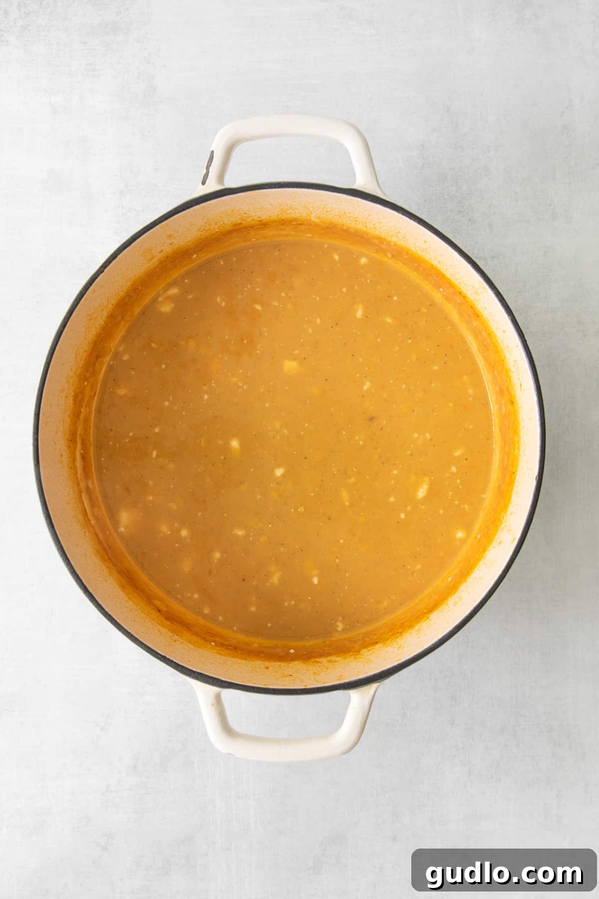 Creamy, blended Mexican Street Corn Soup in a stockpot, showing its smooth texture before toppings are added.