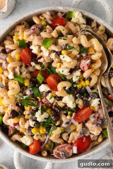 Fiesta Pasta Salad 8 A bowl of pasta salad with black beans, tomatoes, and corn, perfectly dressed and ready to be served, topped with fresh cilantro.
