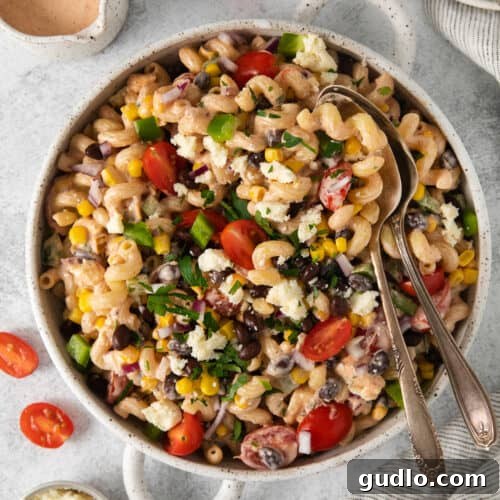 Fiesta Pasta Salad 11 A bowl of vibrant Mexican pasta salad with black beans, tomatoes, and corn, perfectly dressed and ready to be served.