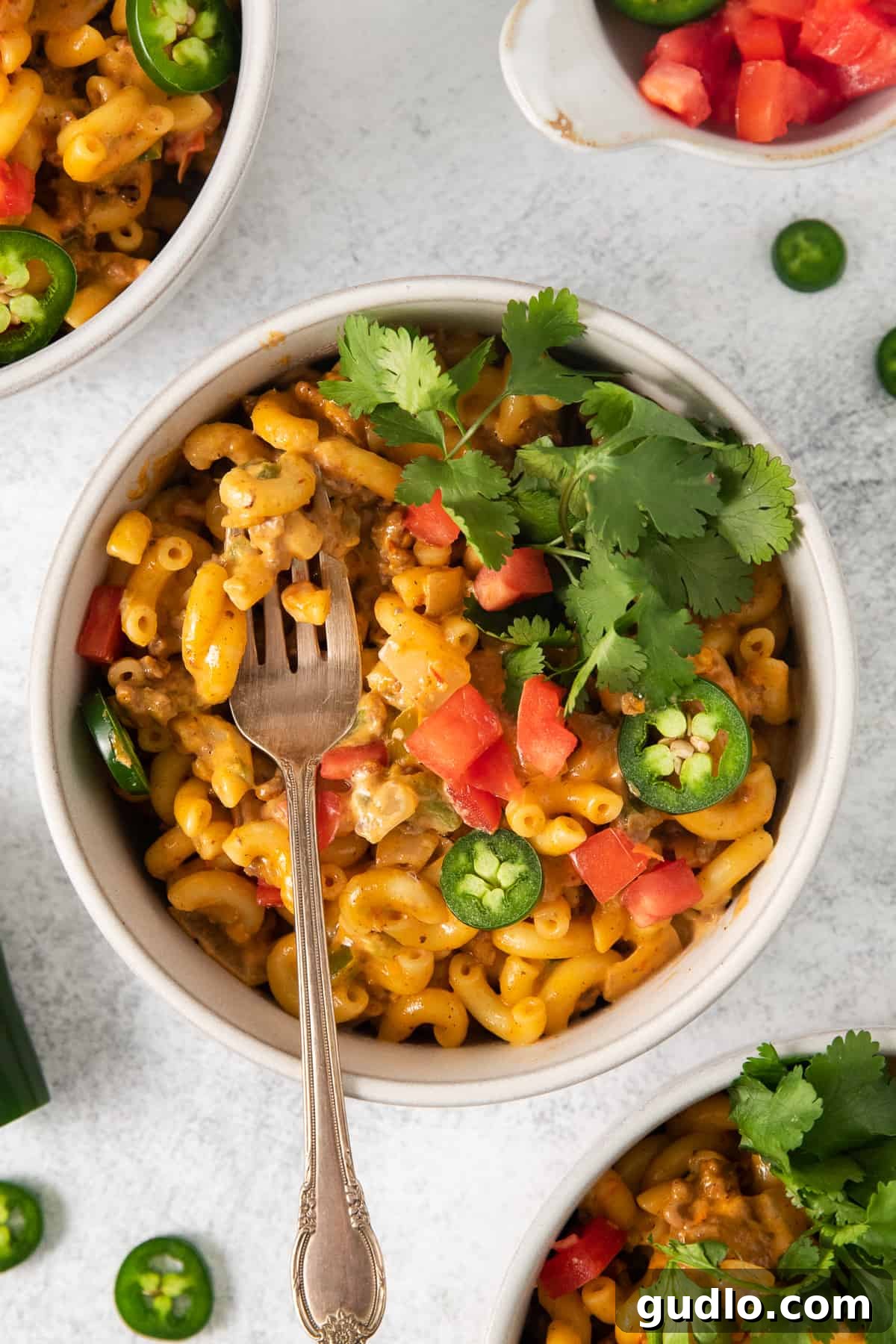 Creamy Taco Mac and Cheese: Your New Favorite 30-Minute Dinner! A bowl of creamy taco mac and cheese, garnished with fresh cilantro, ready to be enjoyed.