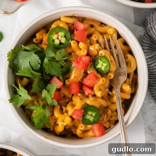 Taco mac and cheese in a bowl, perfectly garnished and ready to serve.