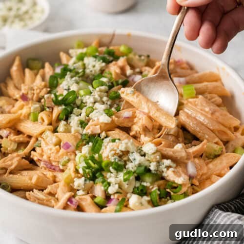A beautifully presented bowl of buffalo chicken pasta salad, garnished and ready for enjoyment.