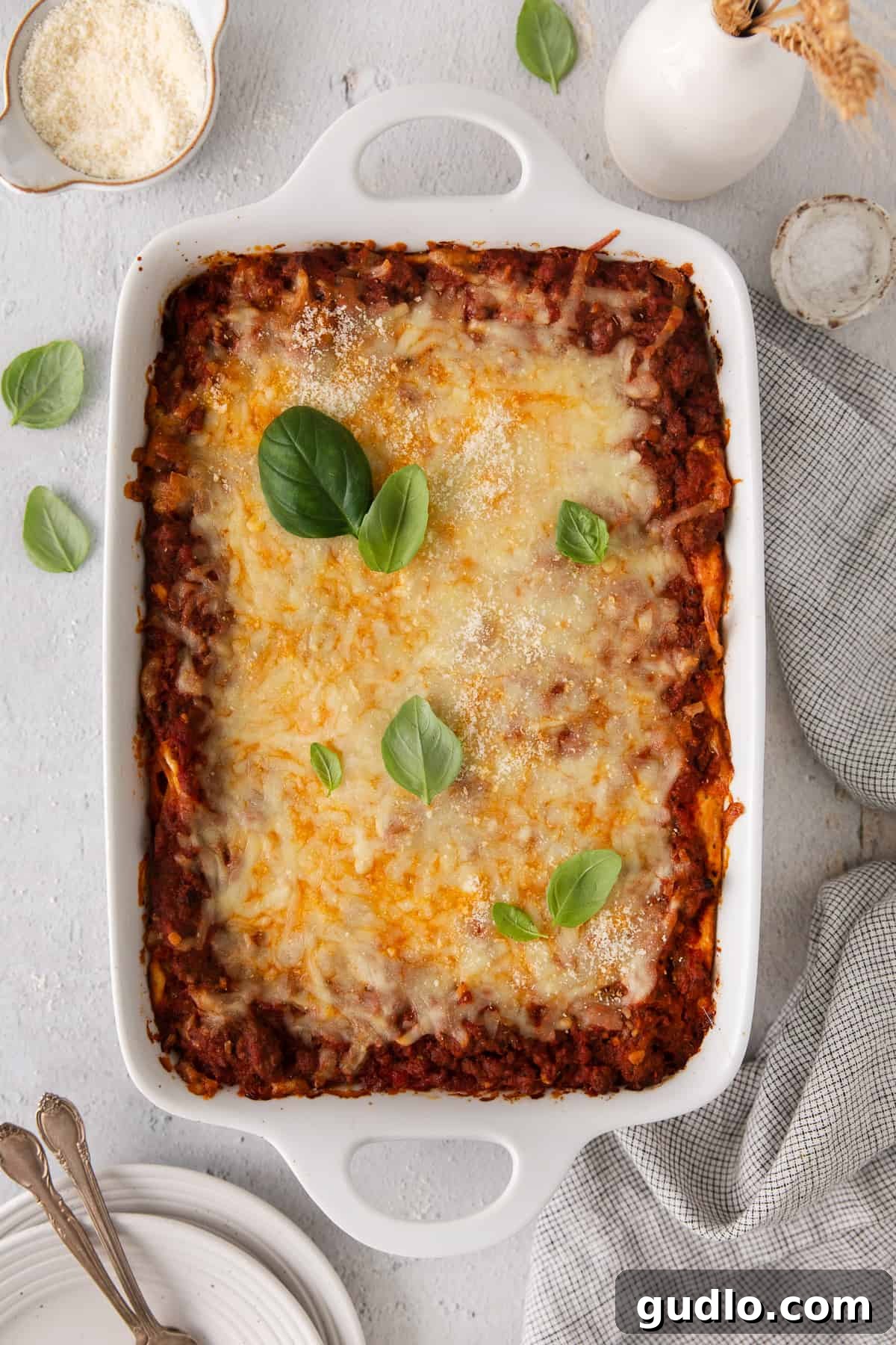 The fully baked Million Dollar Spaghetti casserole, topped with melted, golden-brown mozzarella cheese, fresh out of the oven in a rectangular baking dish.