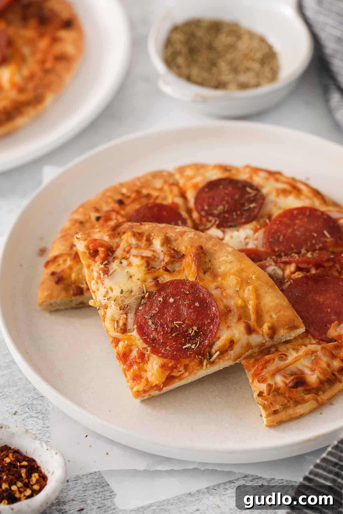 Air Fryer Frozen Pizza: Quick, Crispy, and Delicious! Crispy air fryer frozen pizza slices served on a white plate, ready to eat.