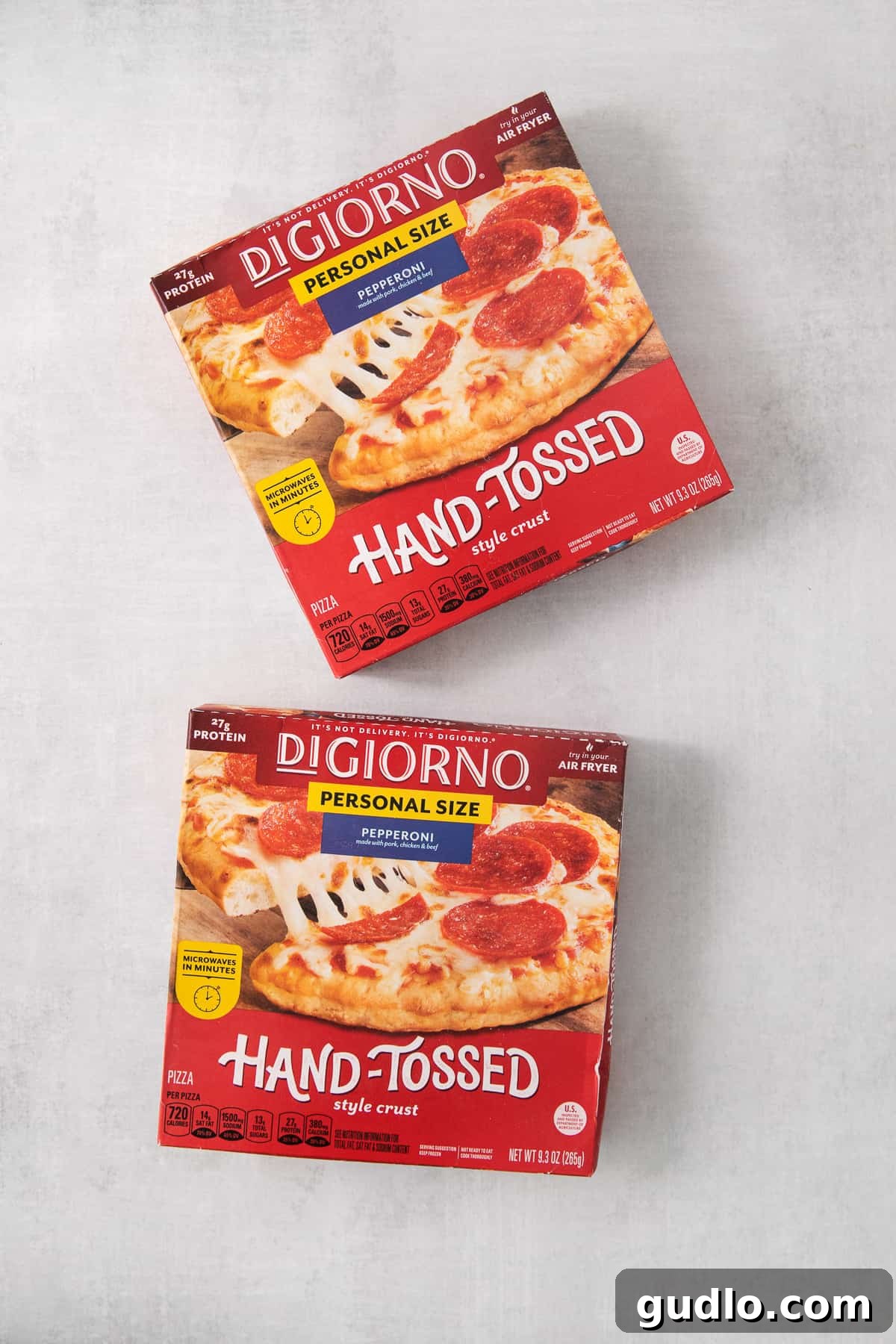 Best Frozen Pizza Brands for Your Air Fryer Assorted boxes of popular frozen pizza brands stacked on a kitchen counter.