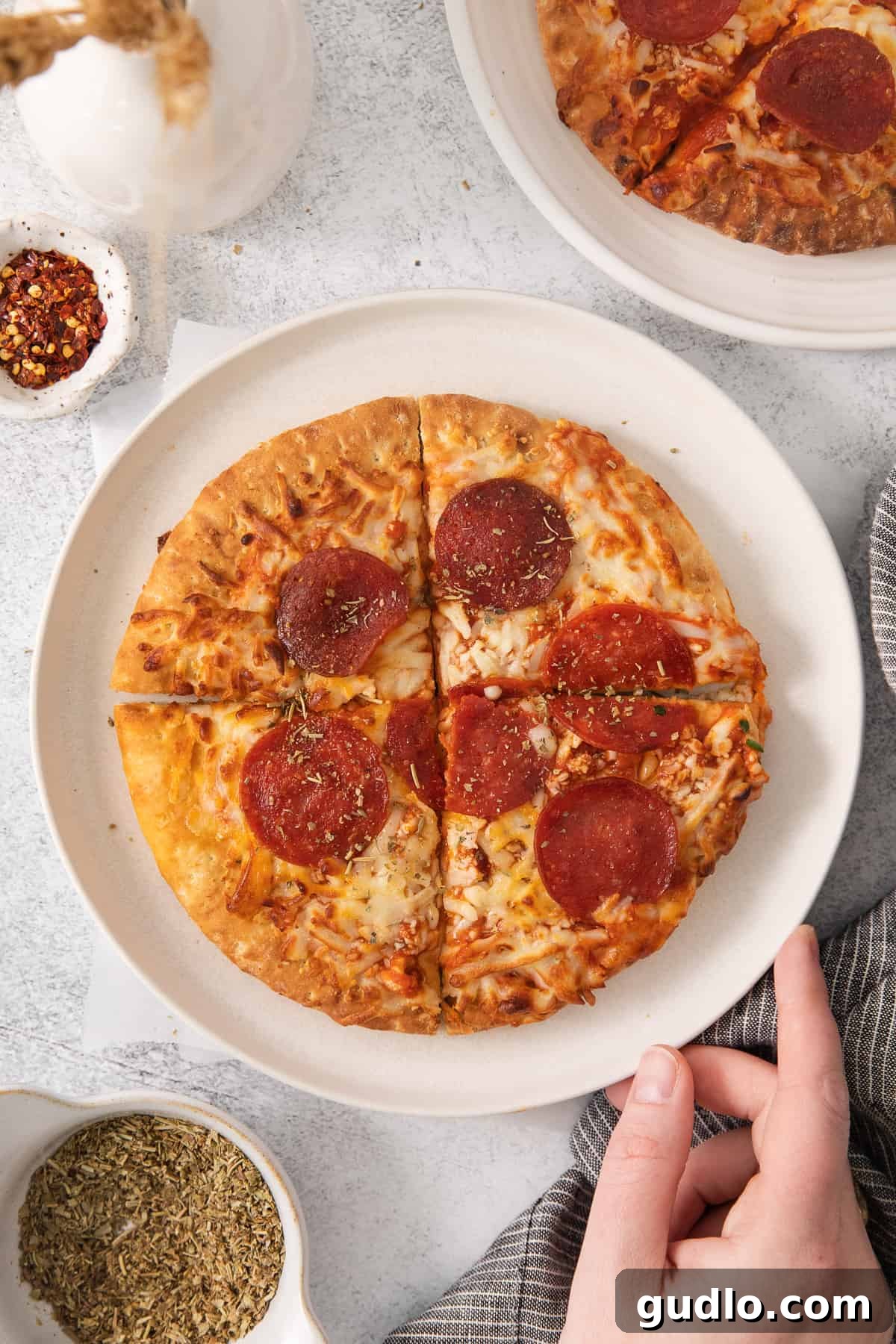 Air Fryer Pizza: Ready to Enjoy! Freshly cooked air fryer pizza slices on a plate, garnished and ready to serve.
