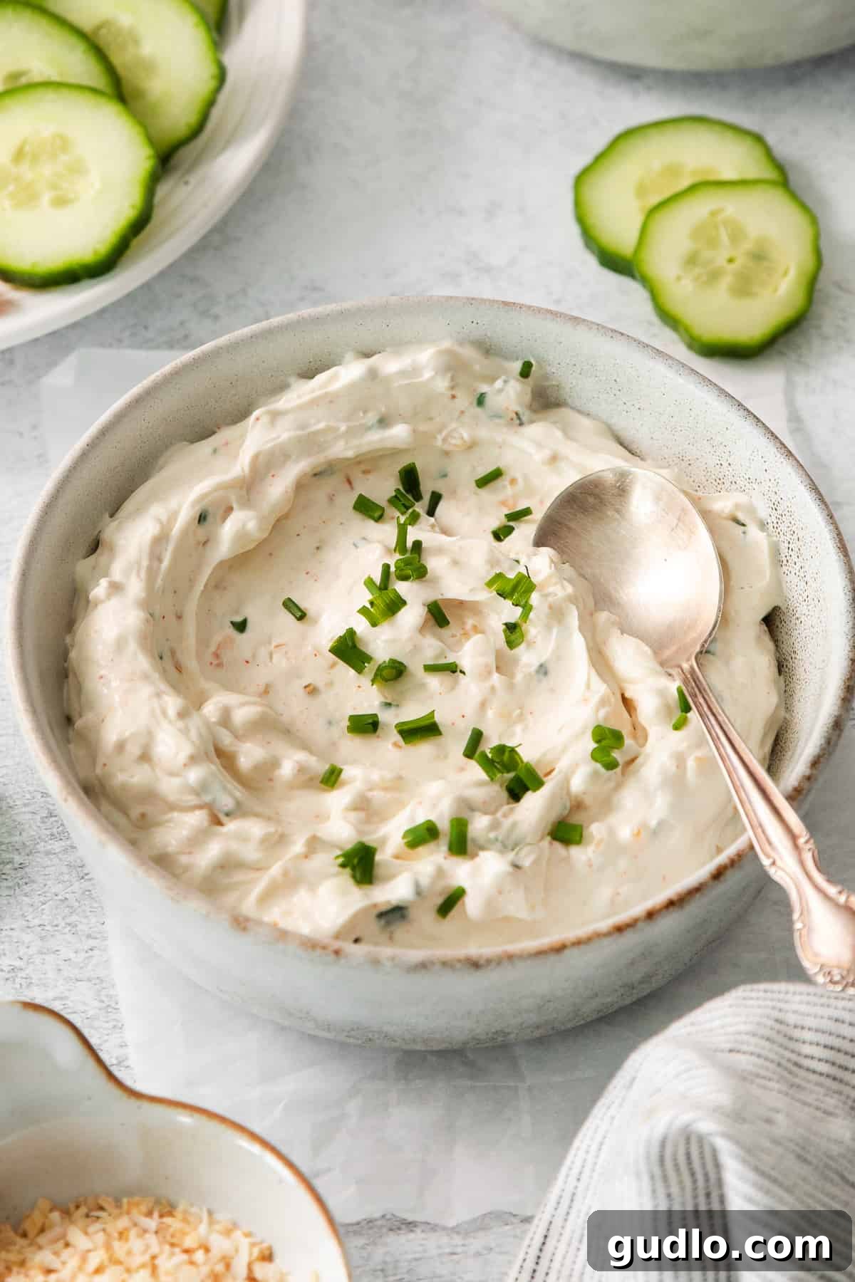 Chip Dip Ready to Scoop A bowl of creamy chip dip with a serving spoon nestled within, inviting guests to indulge.
