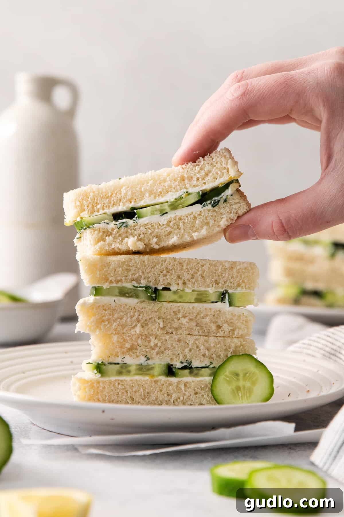 Refreshing Cucumber Cream Cheese Sandwiches 2 Serving cucumber sandwiches with cream cheese and dill, perfectly cut.