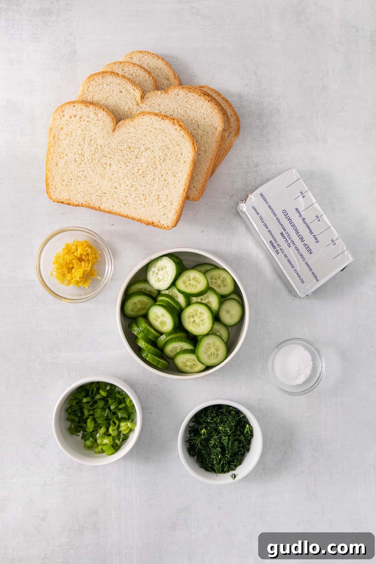 Refreshing Cucumber Cream Cheese Sandwiches 3 All fresh ingredients laid out for making cucumber sandwiches: cucumbers, dill, green onions, lemon, cream cheese, and bread.