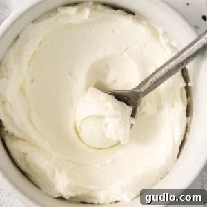 Refreshing Cucumber Cream Cheese Sandwiches 7 whipped cream in a bowl with a spoon, hinting at homemade cream cheese.