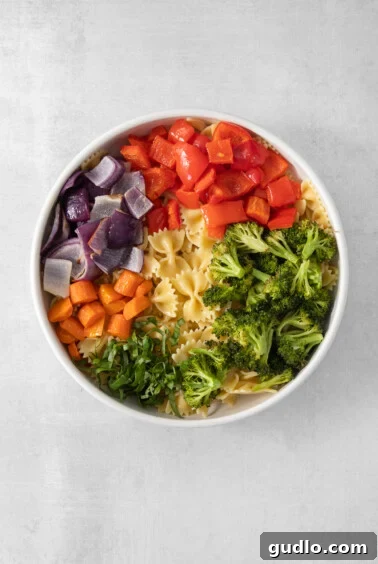 Farfalle Fiesta Salad 12 a white bowl filled with pasta and vegetables.